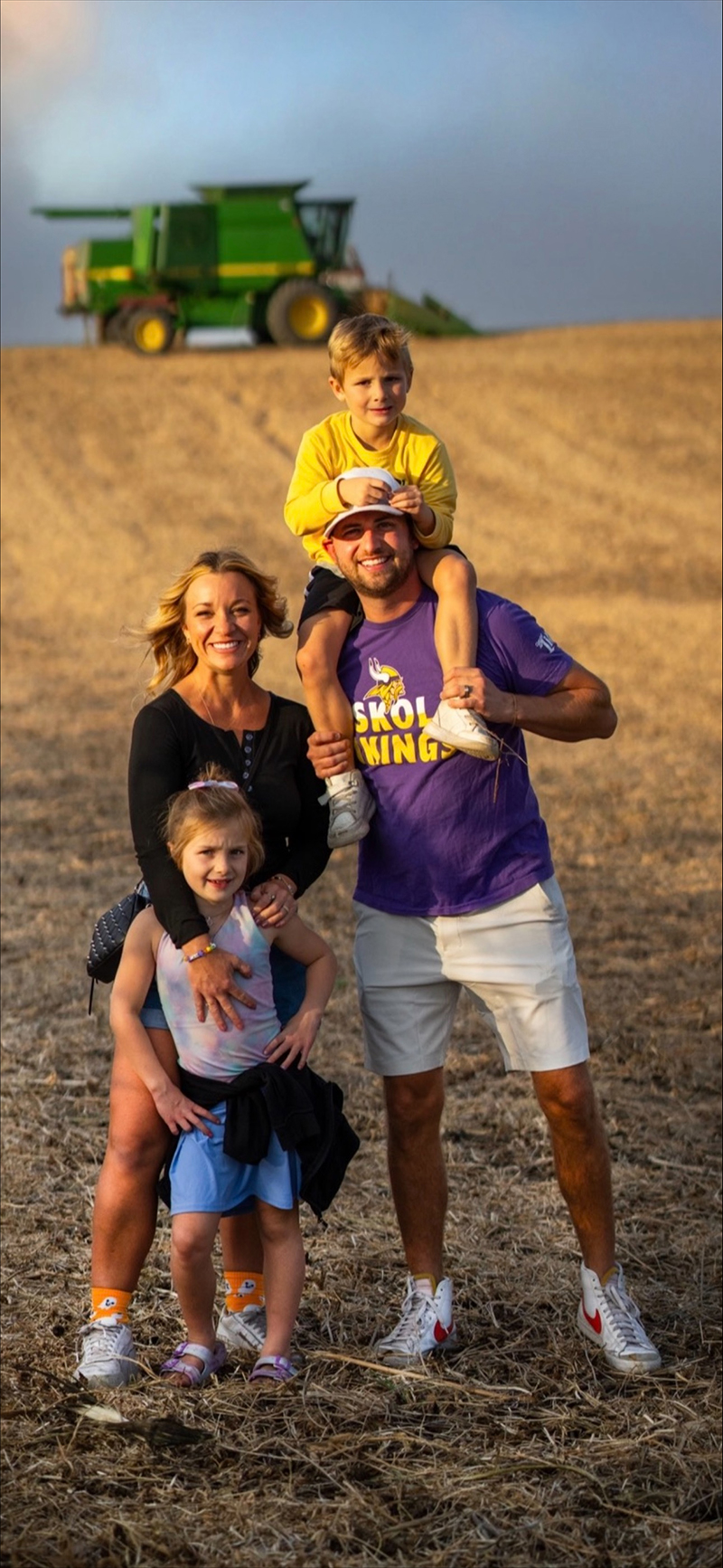 John Zeigler poses with his family on a farm field