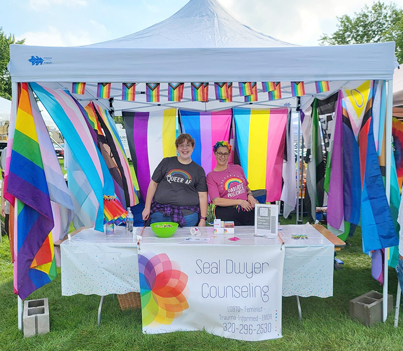 Seal Dwyer standing behind a table at an outdoor event