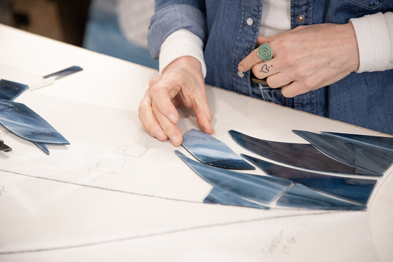 Stacia Goodman starts to map out a mosaic.